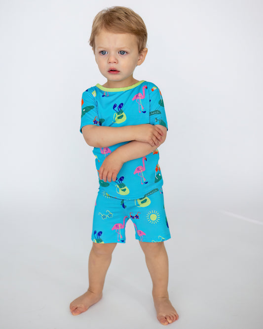 Blue kids' swimsuit set featuring colorful flamingo and sun patterns, made of soft, breathable fabric.