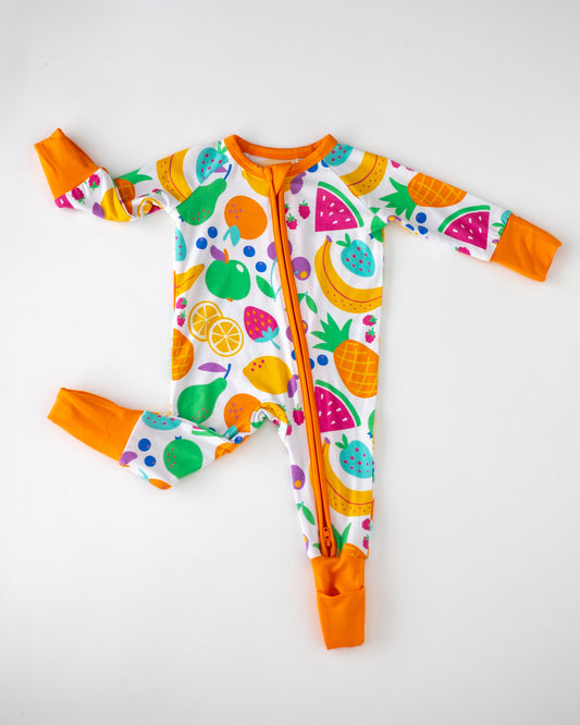 Colorful fruit print baby onesie with orange cuffs and zipper, made from soft, breathable fabric.