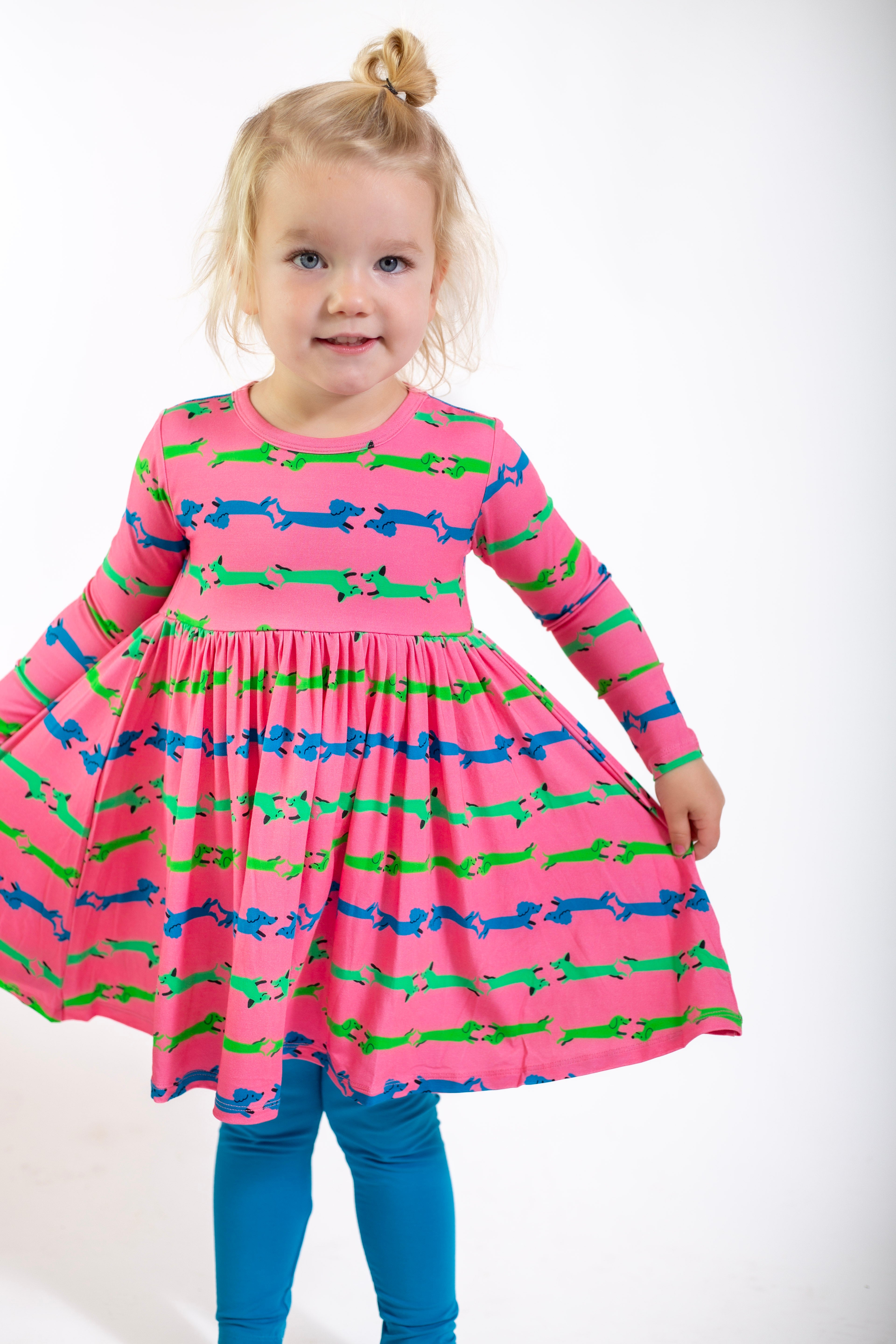 Colorful pink dress for girls adorned with playful dachshund prints, perfect for casual outings.