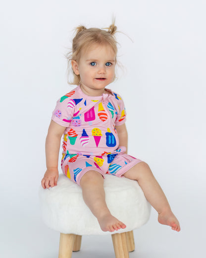 Adorable toddler in a pink ice cream-themed short set, perfect for summer fun and playtime.