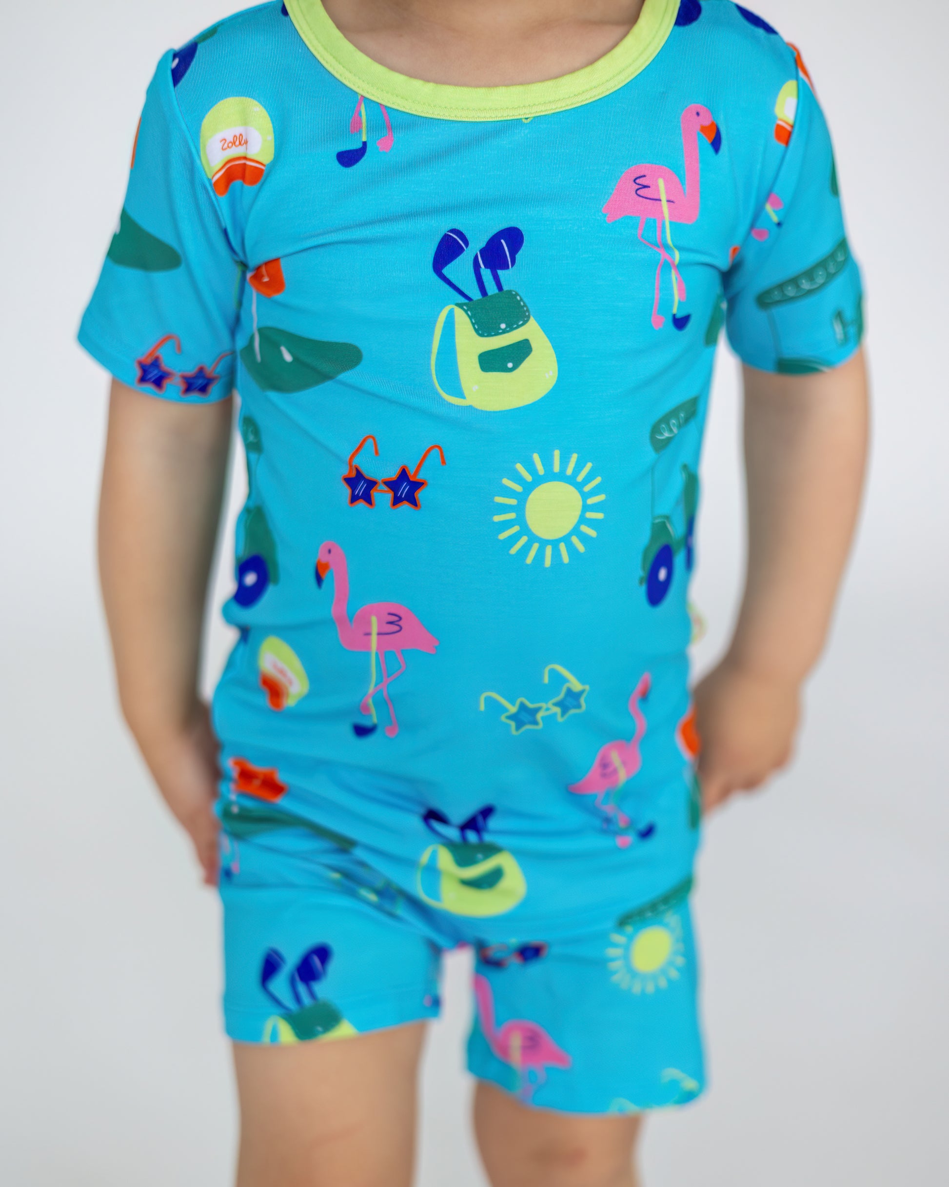 Kids' blue summer pajama set with colorful flamingo and beach-themed prints, soft and comfortable material.