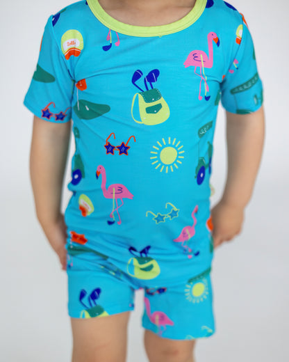 Kids' blue summer pajama set with colorful flamingo and beach-themed prints, soft and comfortable material.