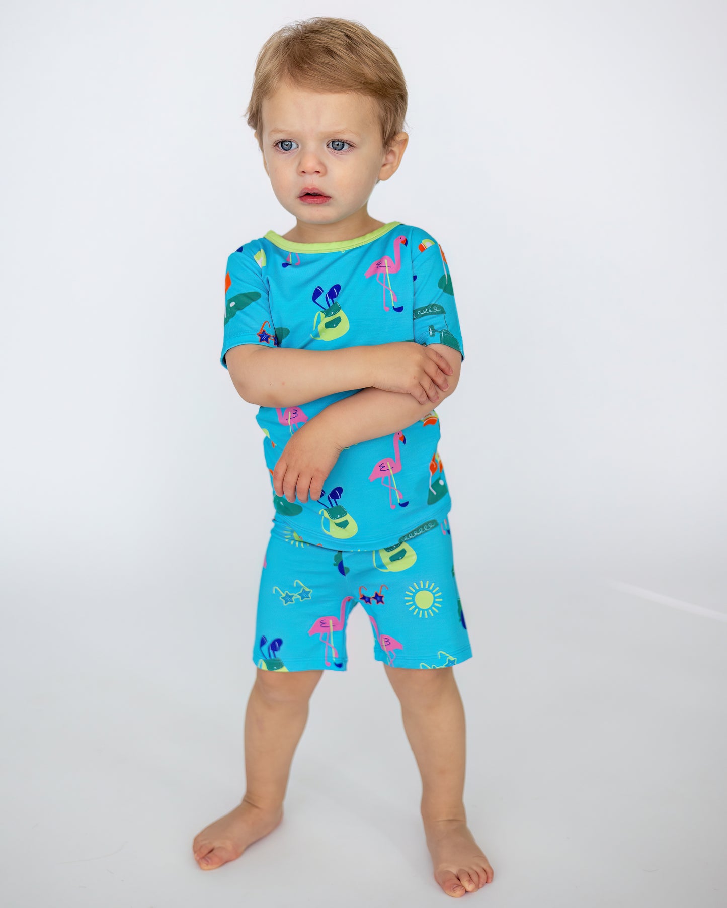 Blue kids' swimsuit set featuring colorful flamingo and sun patterns, made of soft, breathable fabric.