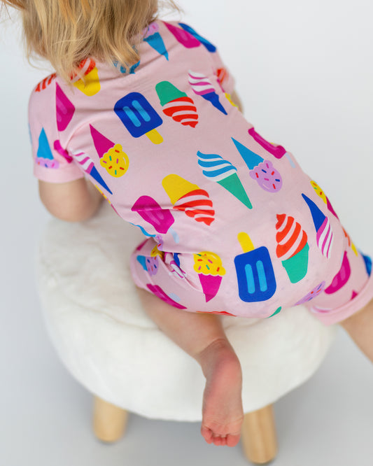 Cute pink toddler pajamas featuring colorful ice cream cone patterns, comfortable cotton material.