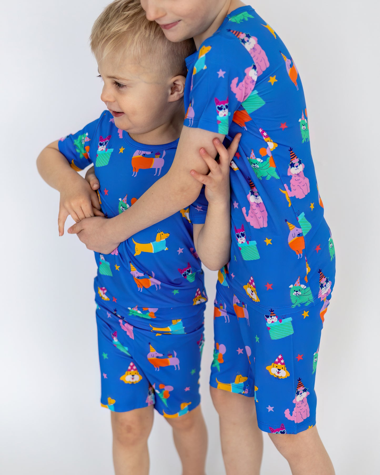 Kids' blue pajamas featuring colorful animal prints, comfortable stretchy material, perfect for sleepwear.