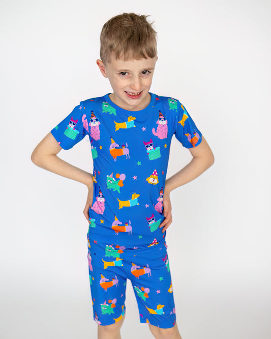 Kids' colorful blue short pajamas with playful animal prints, made of soft, stretchy fabric.