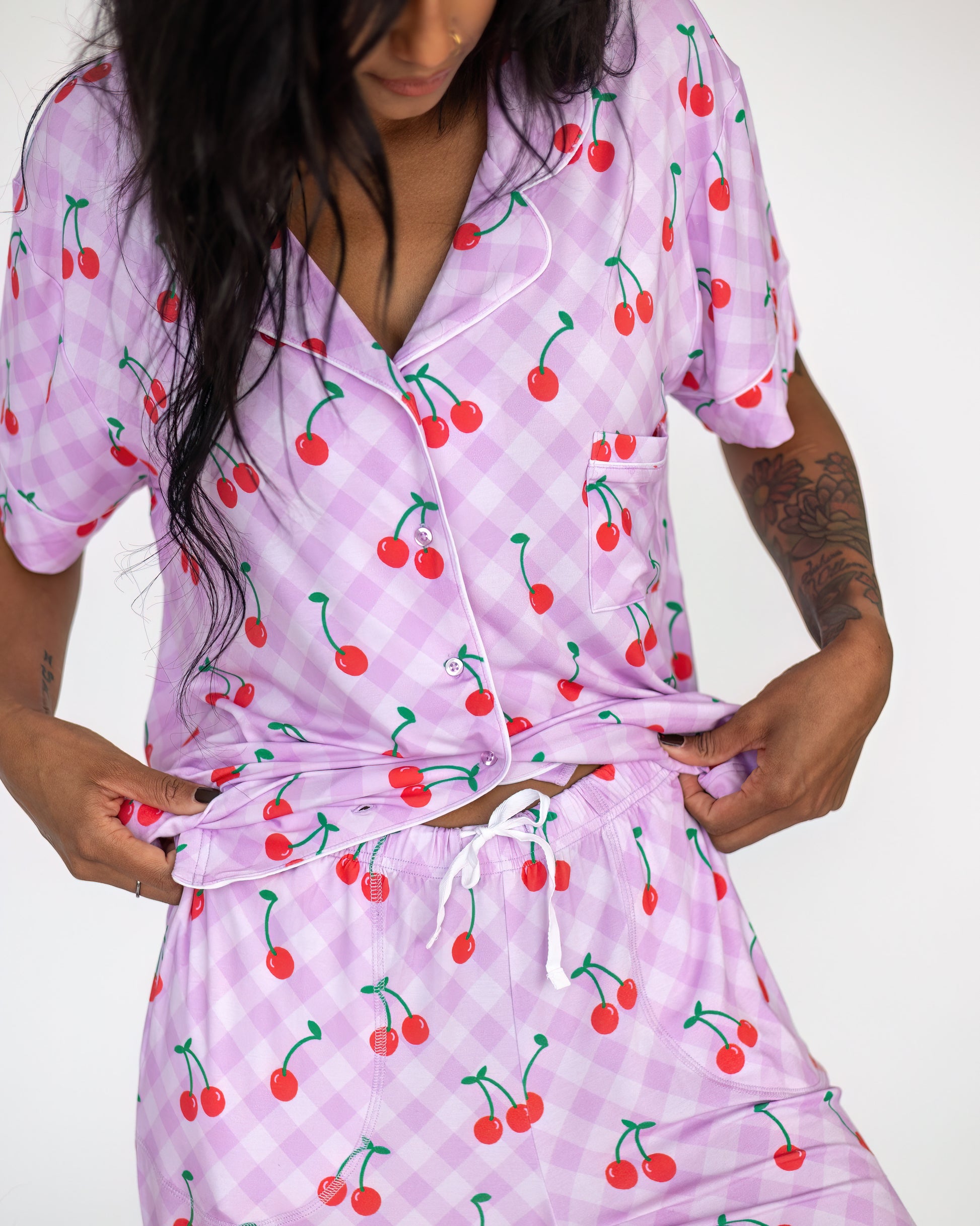 Women's cherry print pajama set in light purple, made from soft fabric with a comfortable fit.