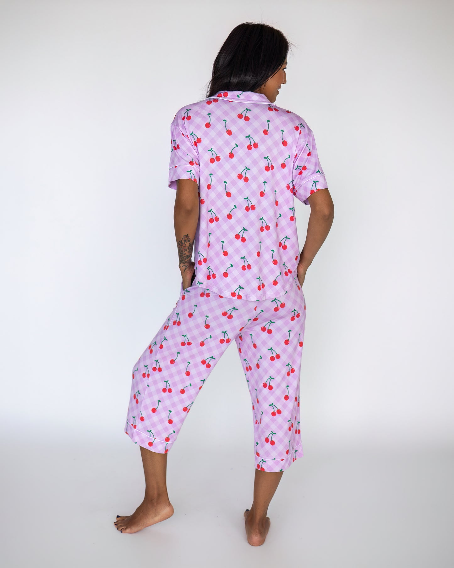 Women's cherry print pajama set in light purple, featuring short sleeves and cropped pants.