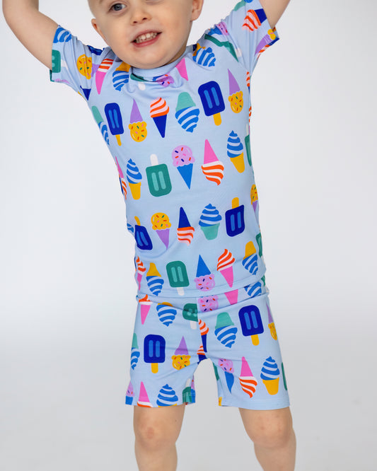Colorful ice cream print kids' swimwear set in light blue, made from comfortable stretch fabric.