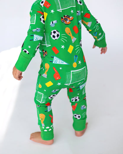 Kids' green soccer-themed pajamas with playful patterns, made from comfortable cotton fabric.