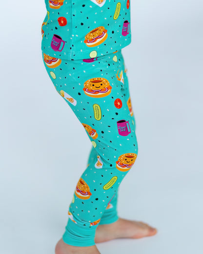 Kids' turquoise leggings with fun food prints, made of soft cotton for comfort and style.