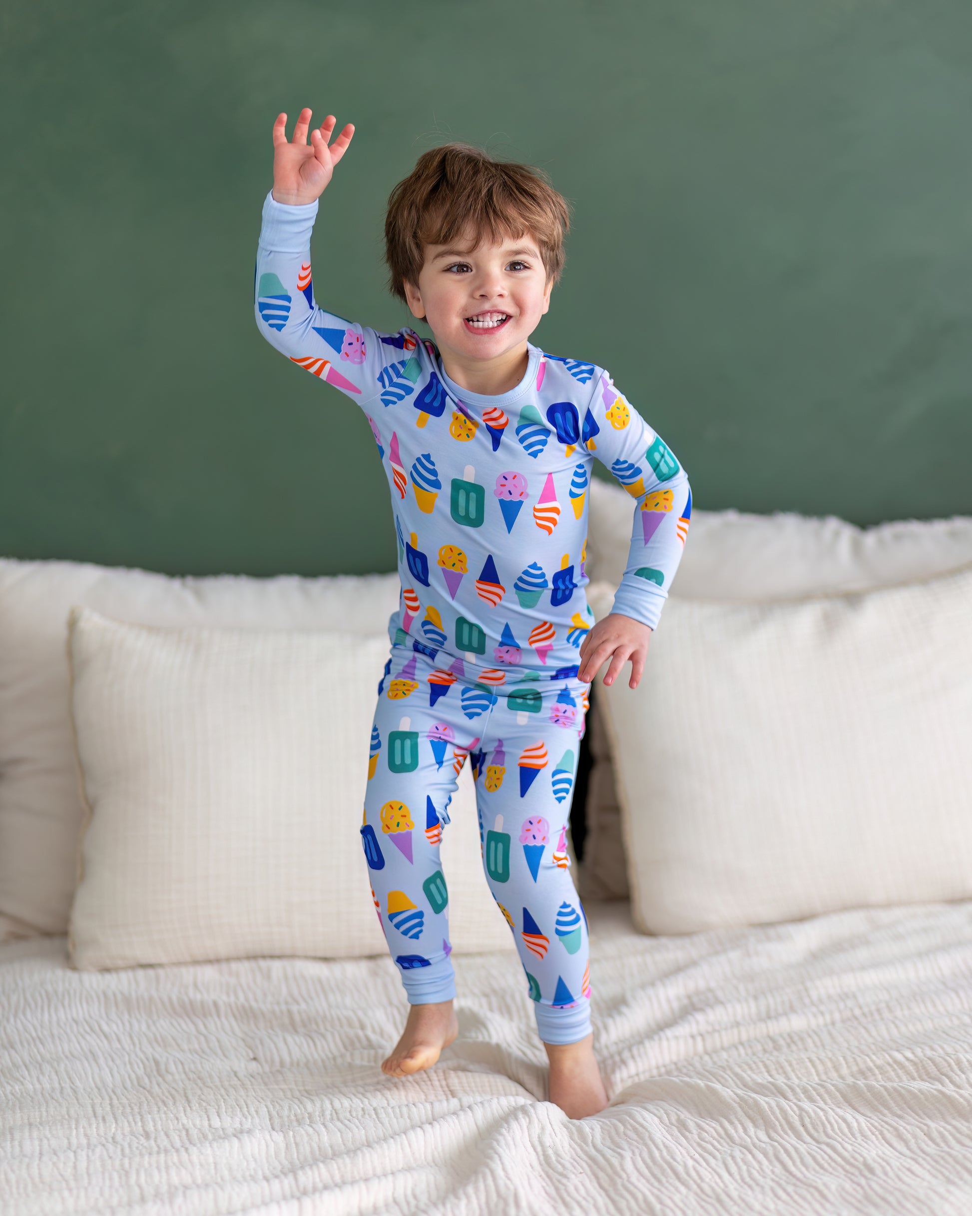 Colorful kids' pajamas featuring ice cream and popsicle patterns, made from soft, breathable fabric.