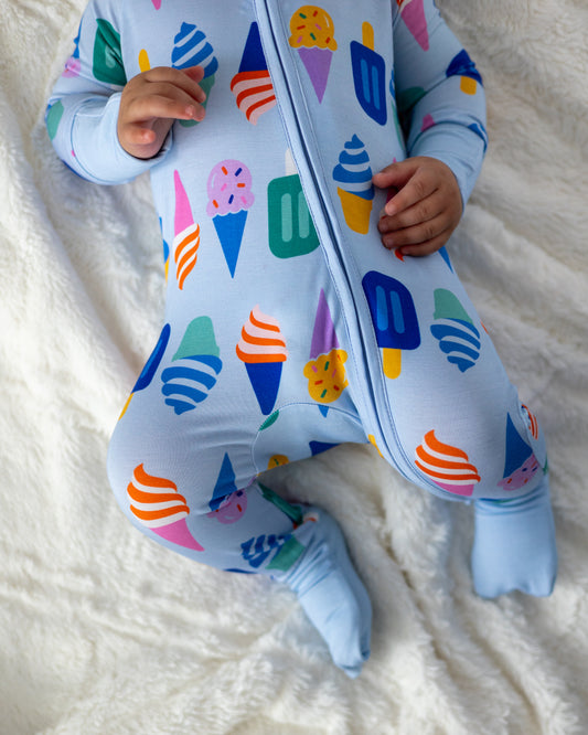 Baby romper in light blue with colorful ice cream cone pattern, soft cotton material, full zip design.