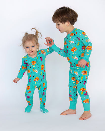 Kids' turquoise pajamas with fun food prints, made from soft, breathable fabric for comfort.