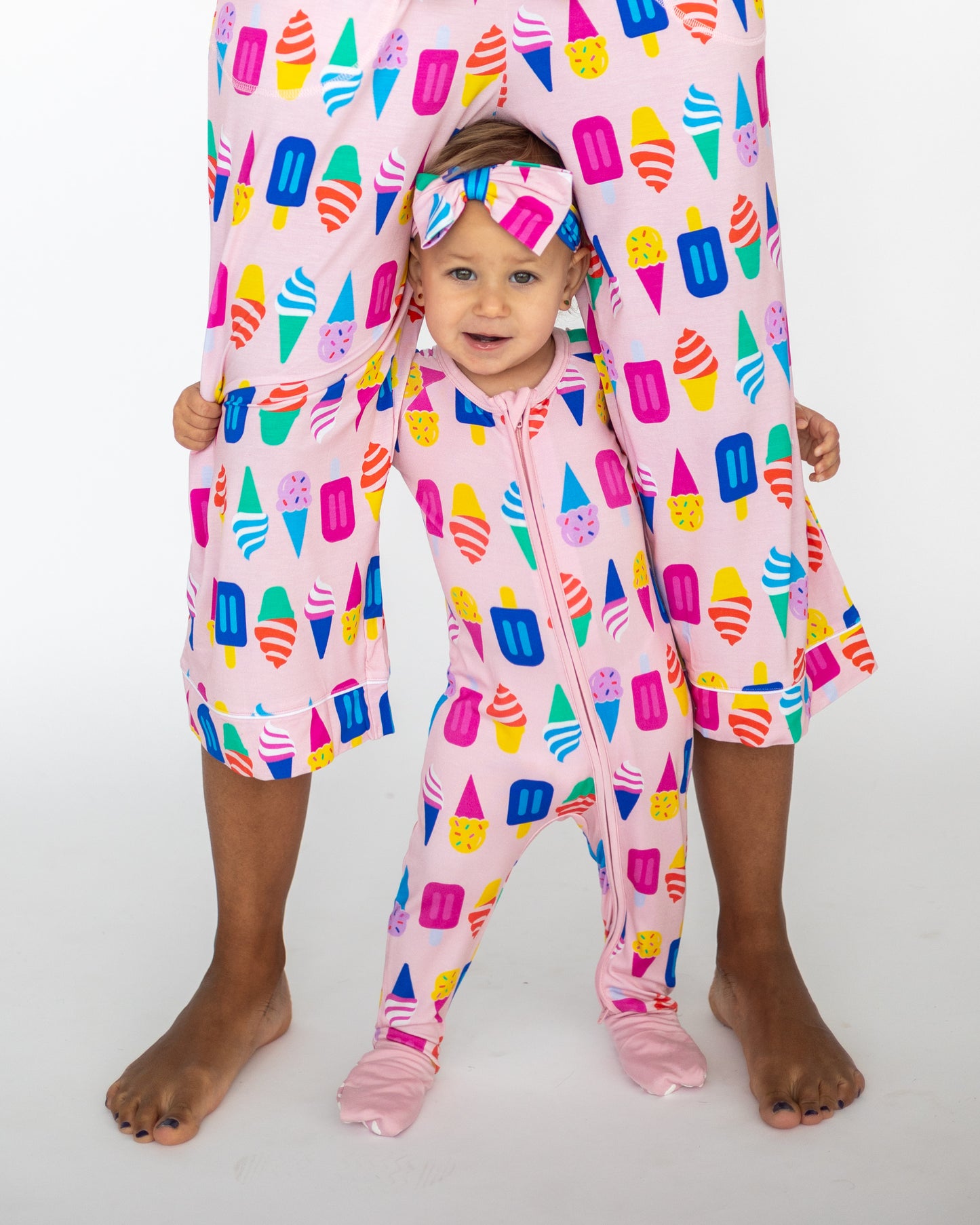 Matching pink ice cream print pajamas for adult and toddler, made from soft cotton material.