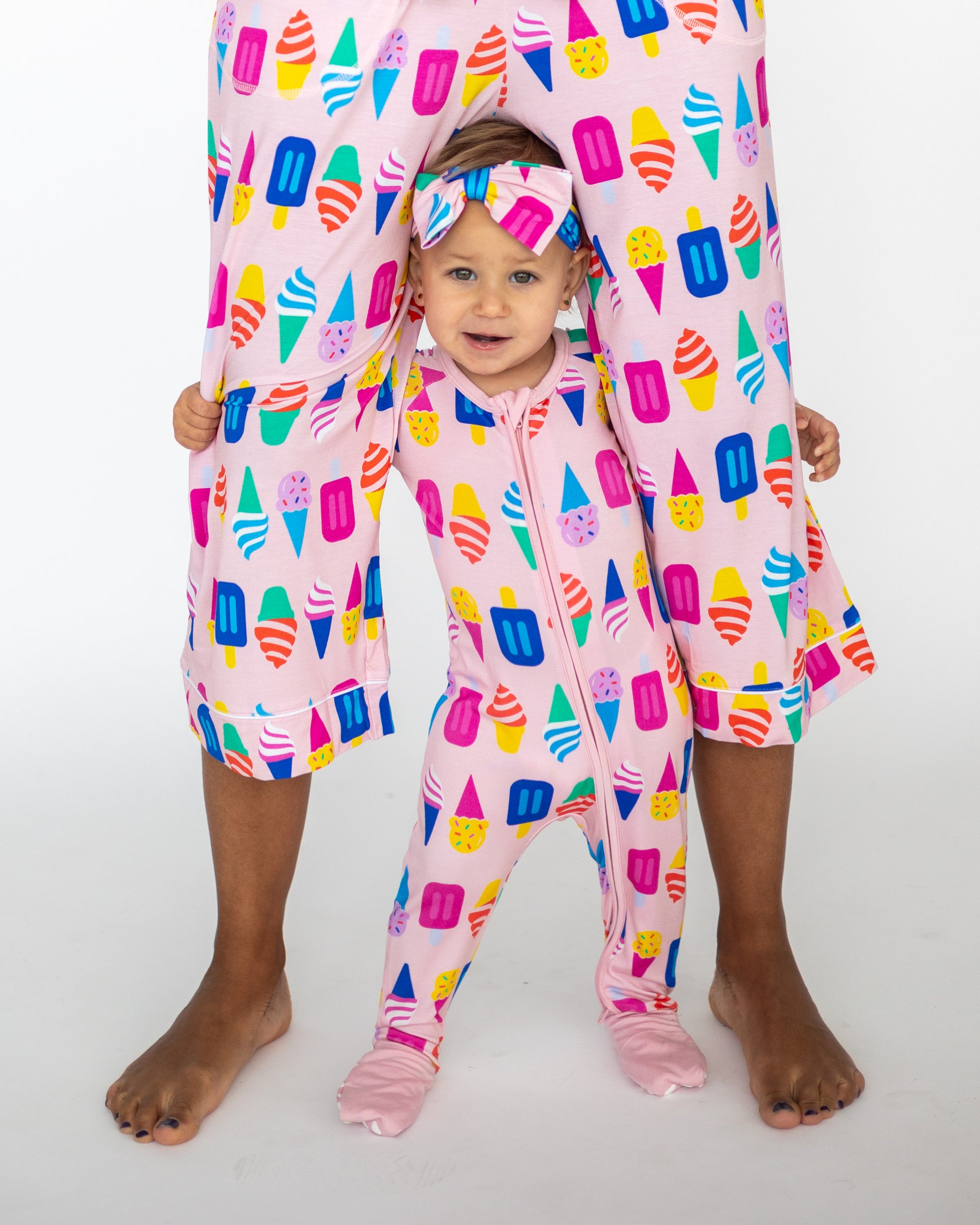 Matching pink ice cream print pajamas for adult and toddler, made from soft cotton material.