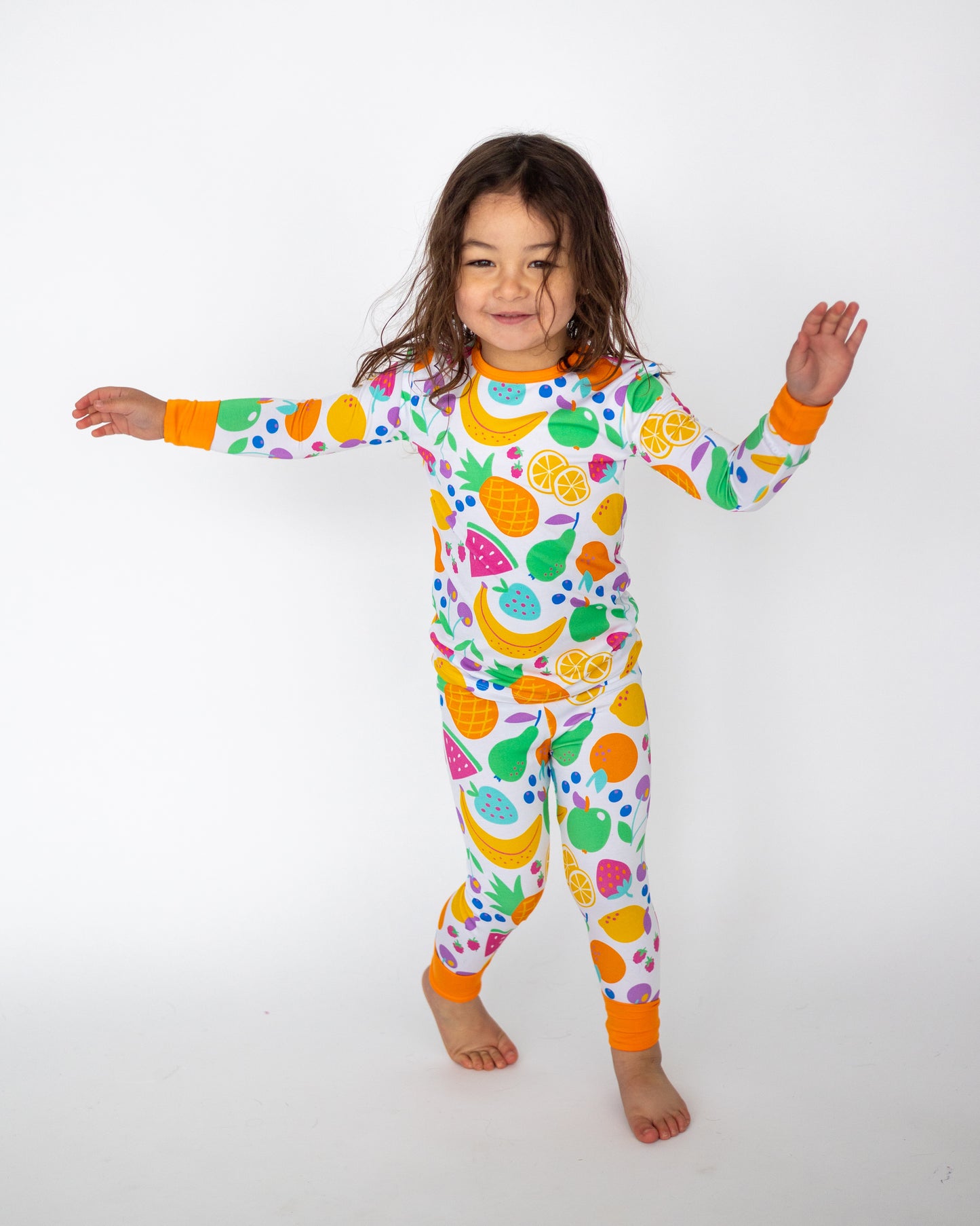 Playful kids' pajama set featuring colorful fruit patterns, made from soft cotton, perfect for comfort and fun.