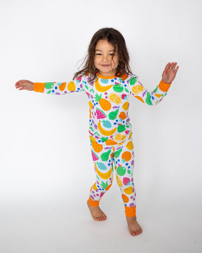 Playful kids' pajama set featuring colorful fruit patterns, made from soft cotton, perfect for comfort and fun.