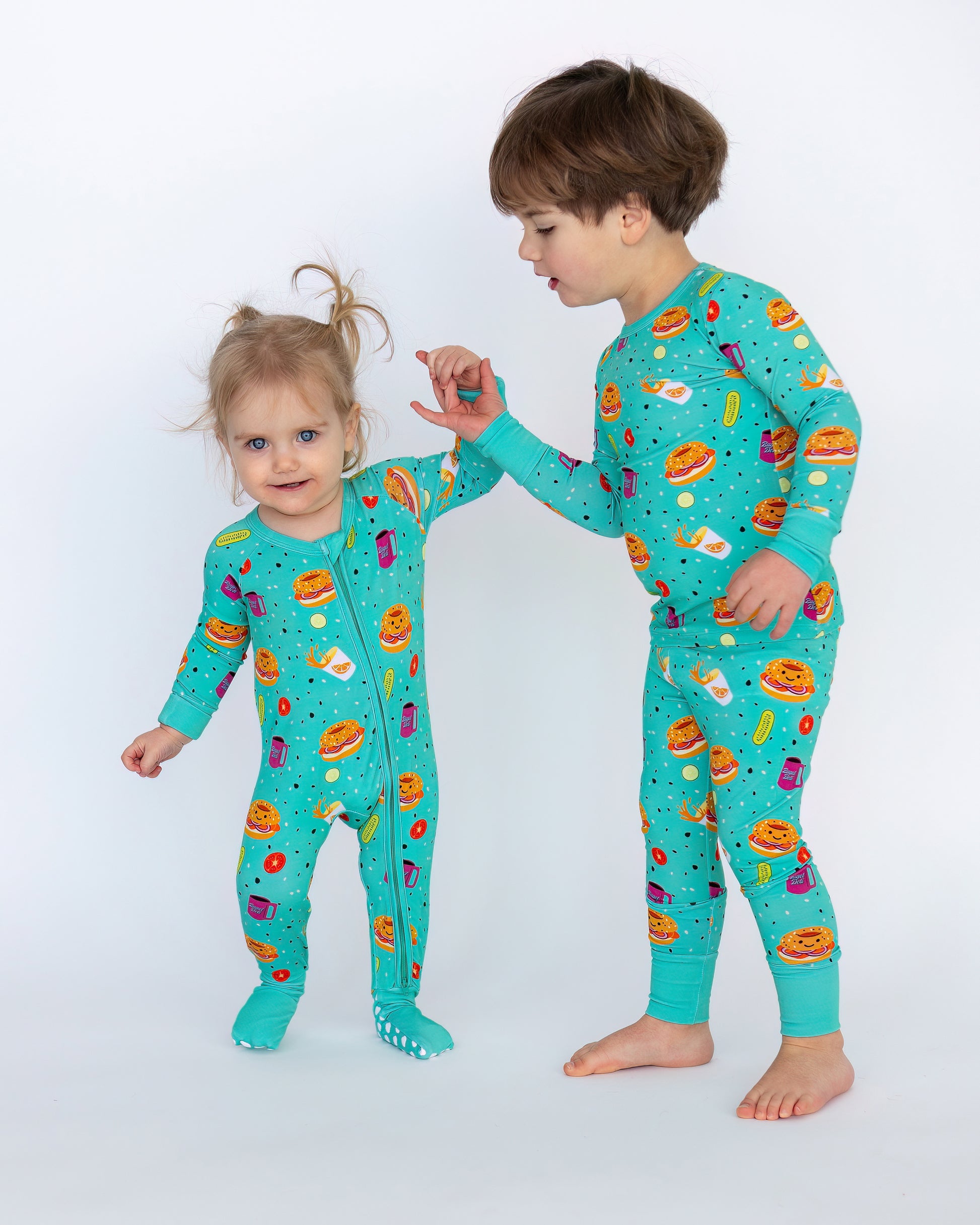 Kids' playful turquoise print pajamas featuring food motifs, soft cotton material for comfort.