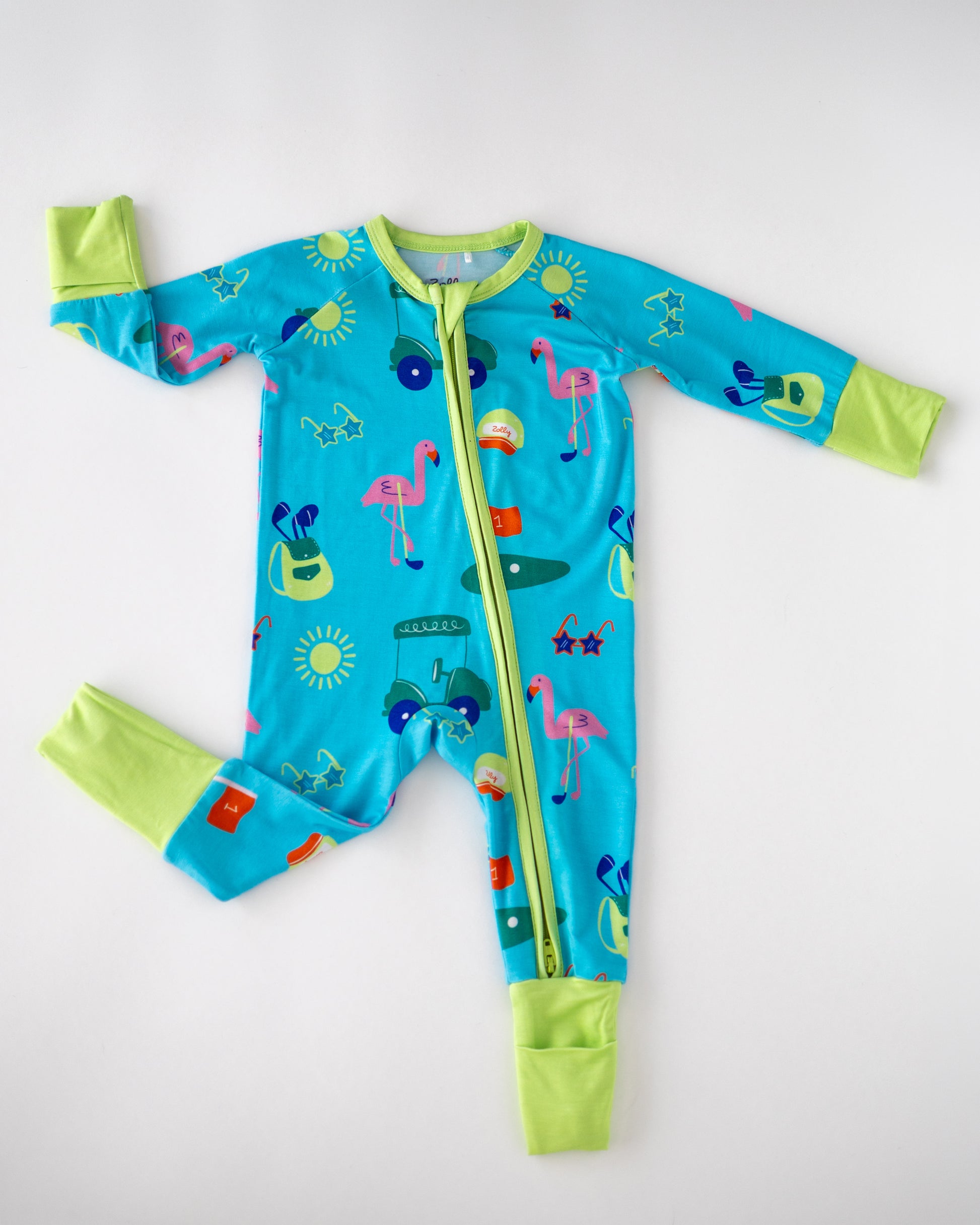 Colorful kids' onesie in blue with fun patterns, vibrant green cuffs, made from soft, breathable material.
