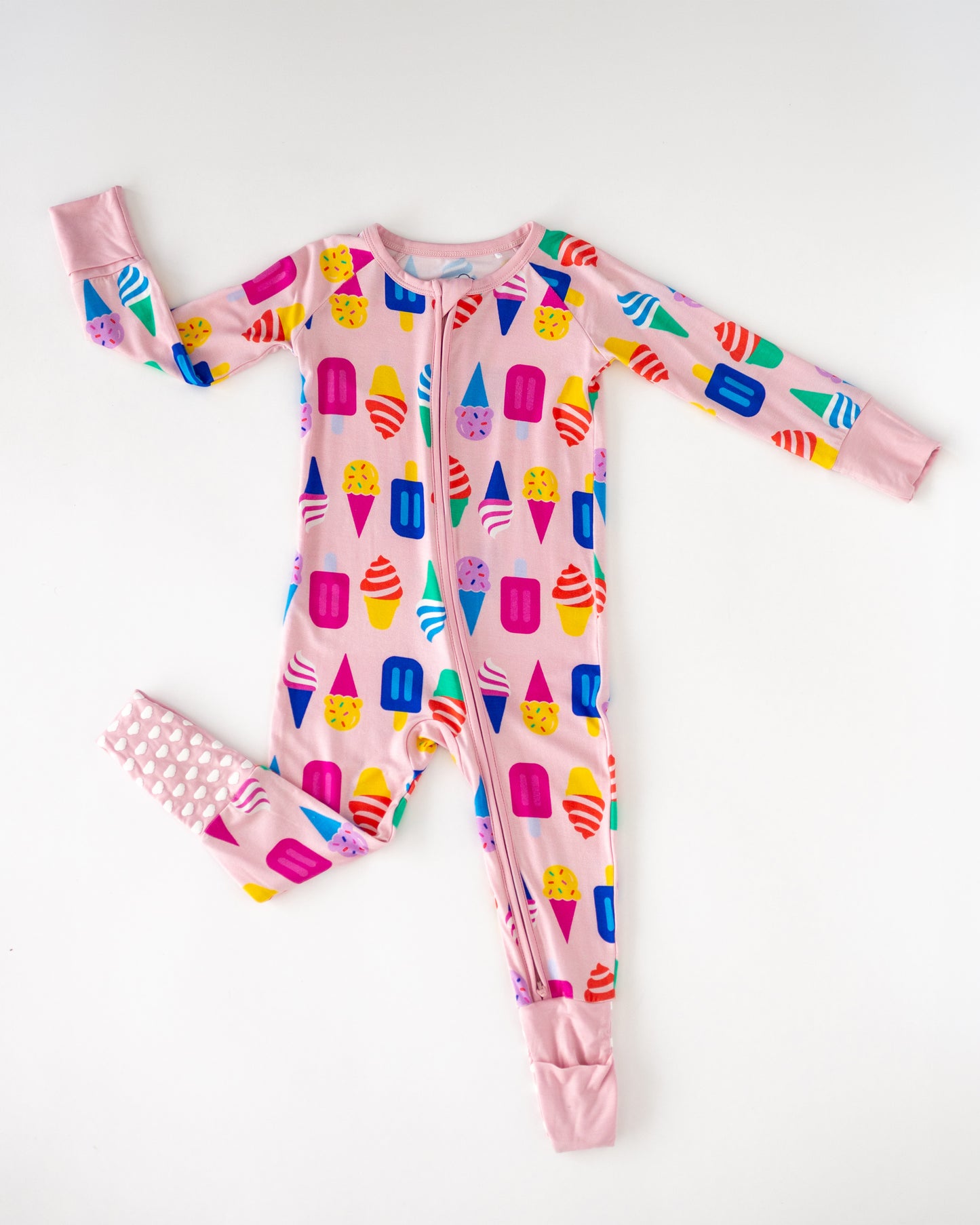 Colorful kids' pajama onesie with ice cream print, pink, made of soft, breathable material.