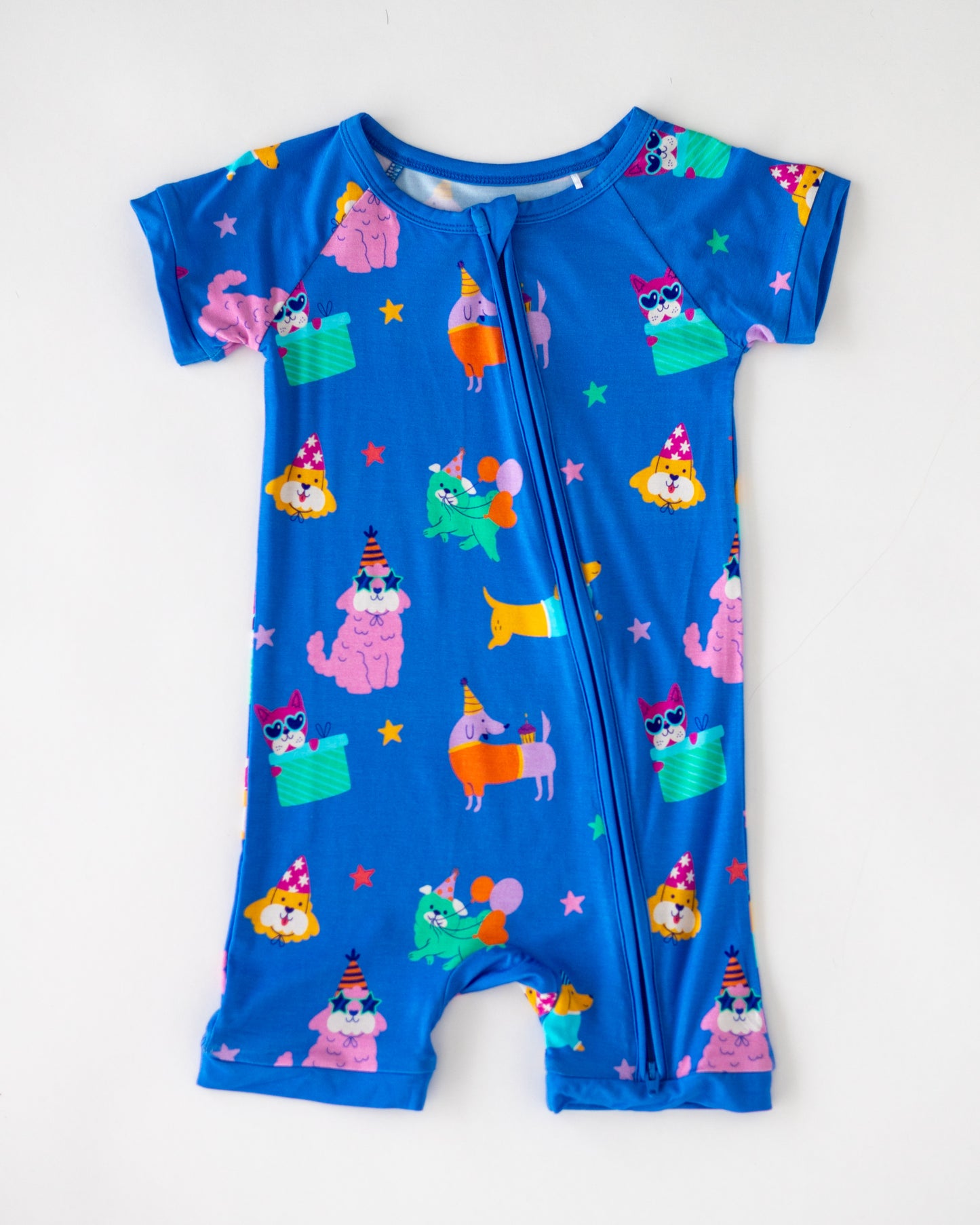Colorful blue romper for kids featuring playful animal party graphics, short sleeves and zipper closure.