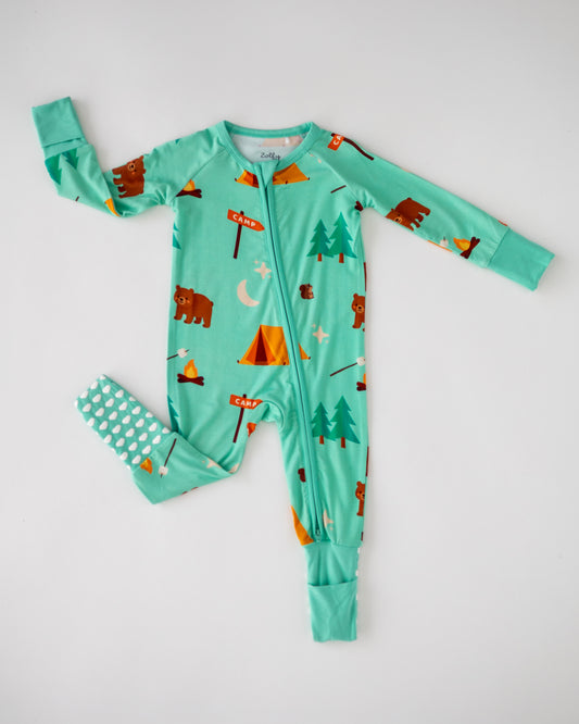 Kids' mint green camp-themed pajamas featuring bears, tents, and trees, made of soft, breathable fabric.