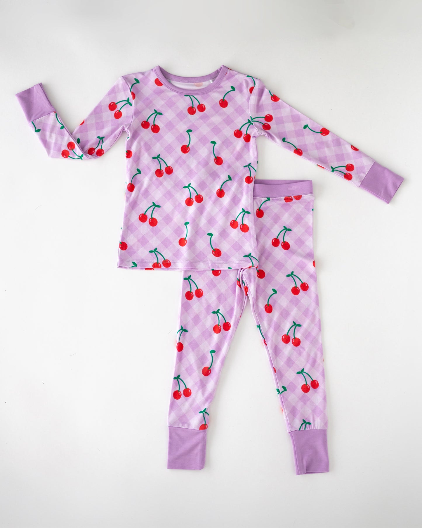 Children's cherry print pajamas set in lavender, soft cotton, long sleeve top and pants.