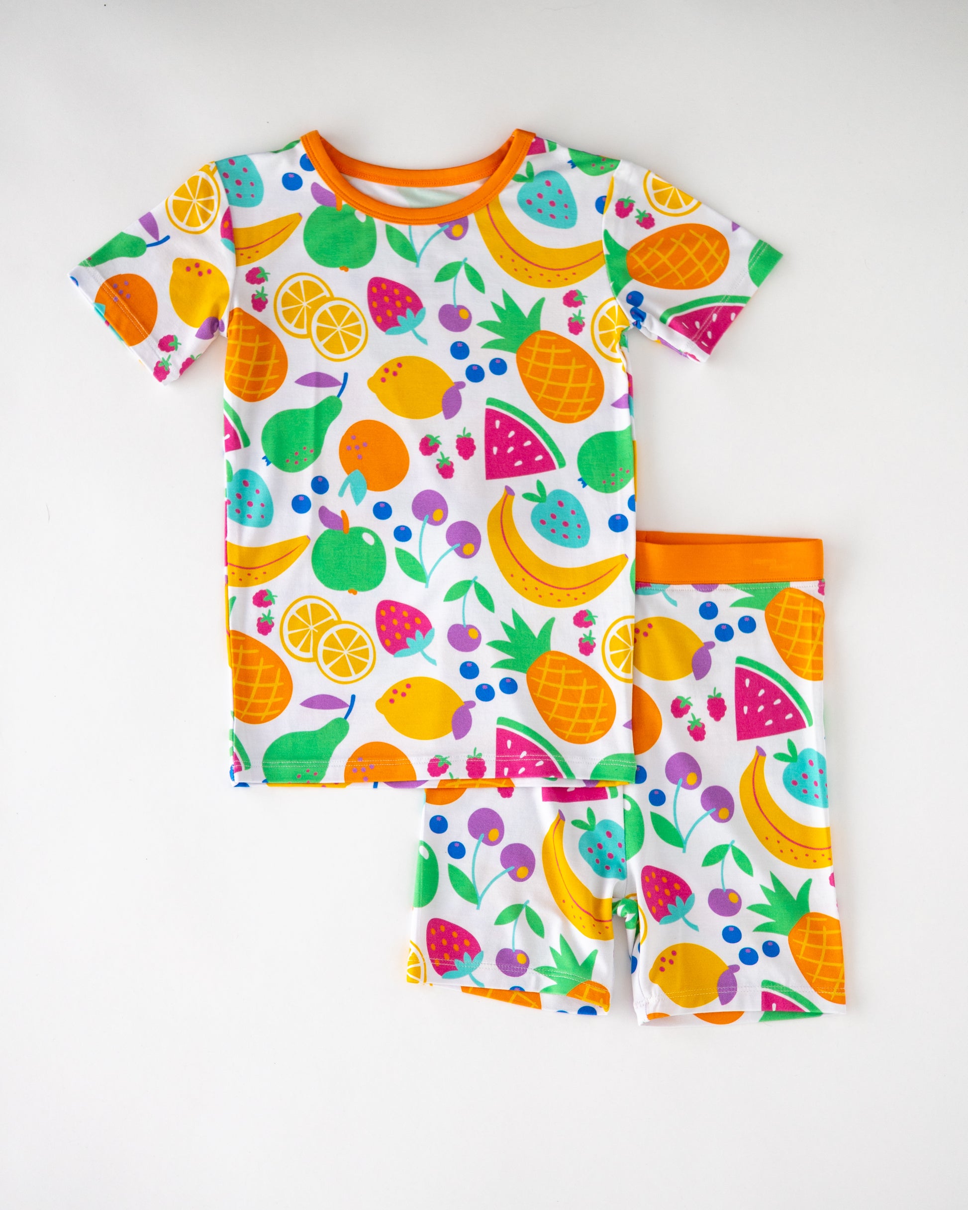 Kids' colorful fruit-patterned pajamas set, short sleeve shirt and shorts, made of soft cotton.