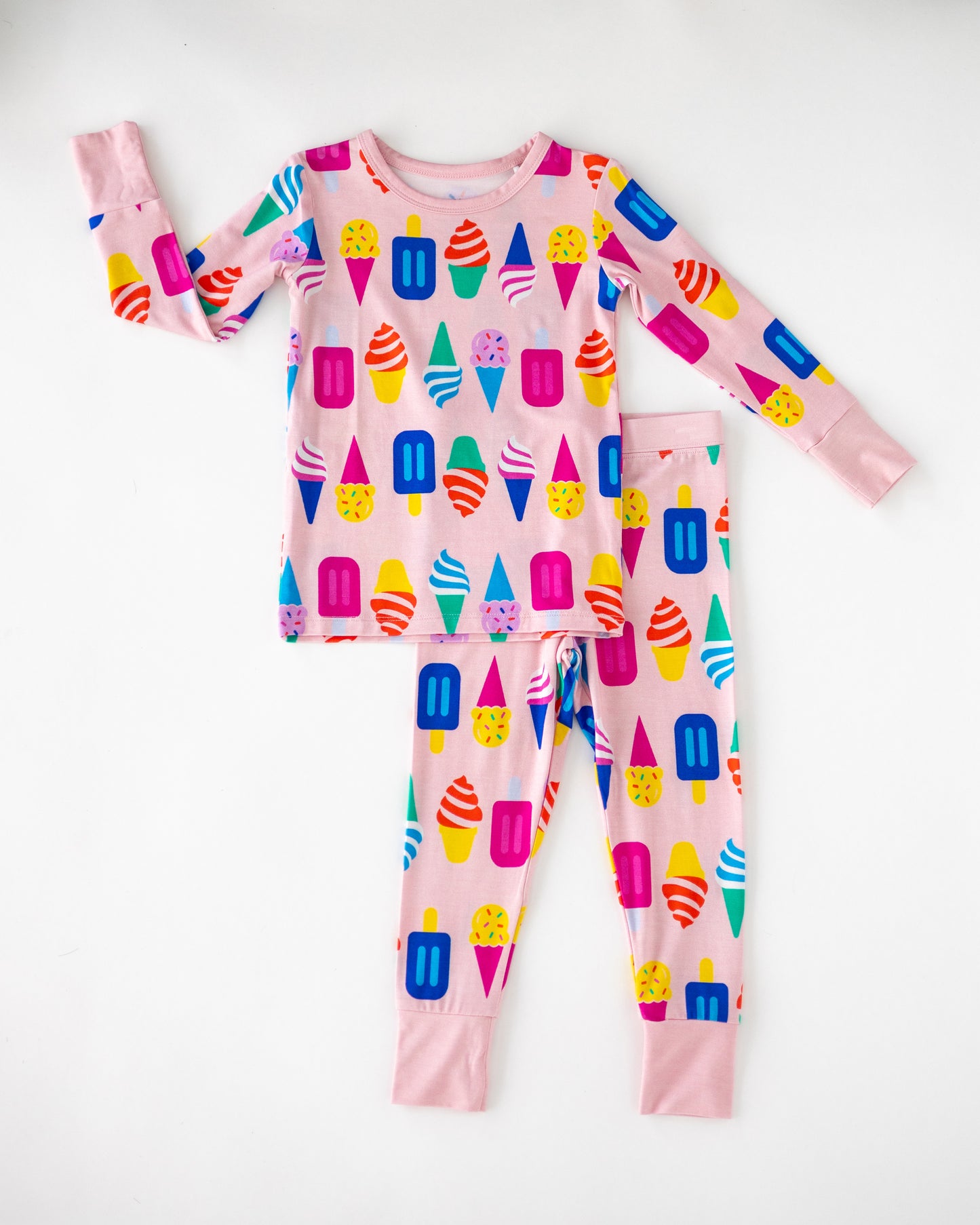 Colorful kids' pajamas set with ice cream and popsicle print, pink, soft cotton material, long sleeves and pants.