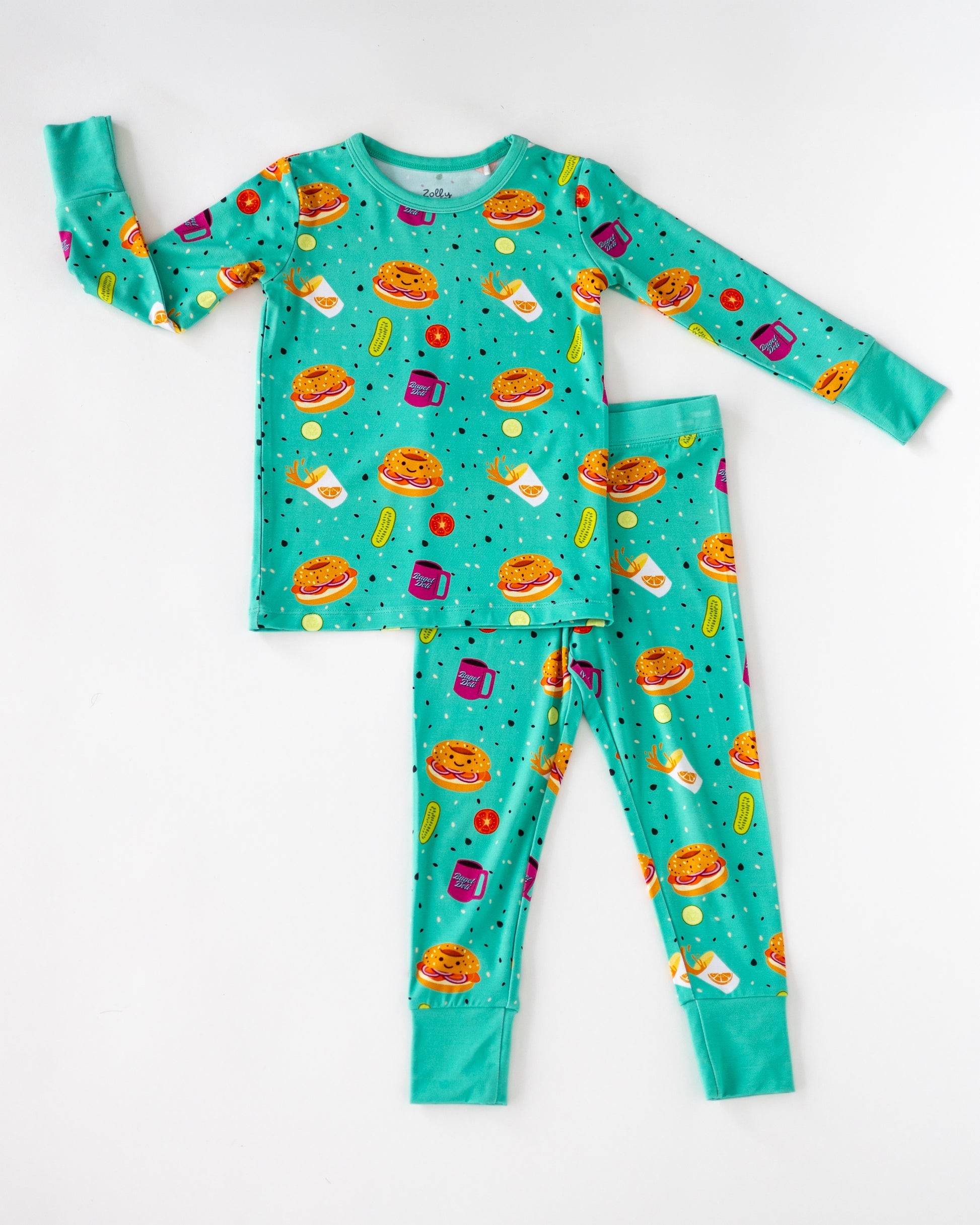 Kids' turquoise pajama set featuring vibrant food prints, made from soft, breathable material.
