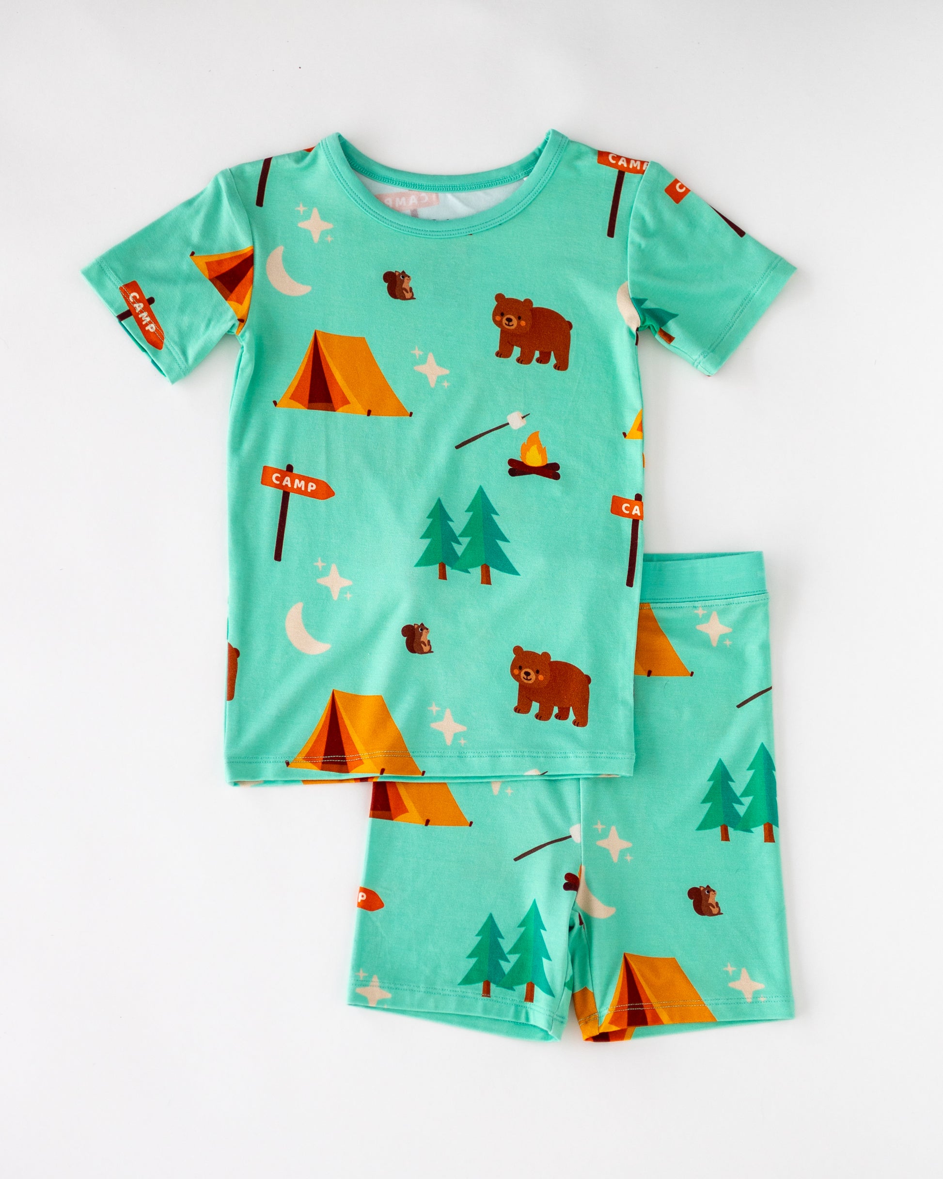 Children's camping-themed pajamas set, light blue, soft cotton, featuring bears, tents, and trees.