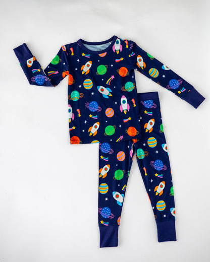 Kids' navy space-themed pajama set with rockets and planets, soft cotton, long sleeve top and pants.