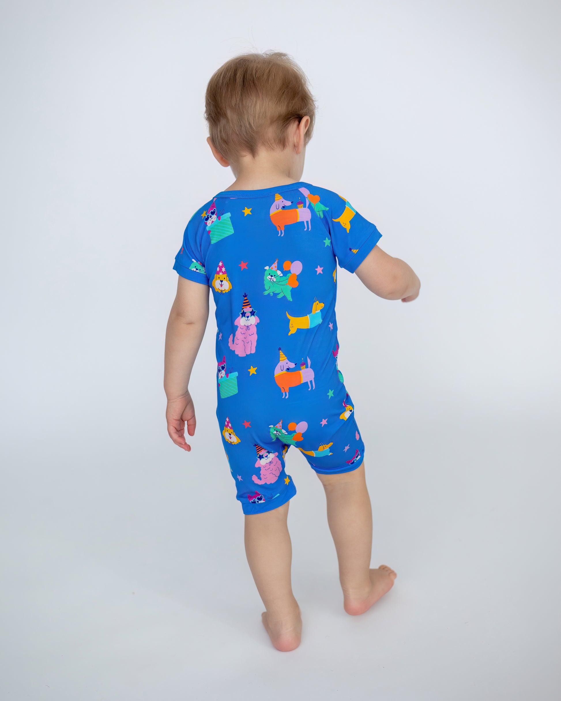 Toddler short-sleeve romper in bright blue with colorful animal prints, perfect for playtime and casual outings.
