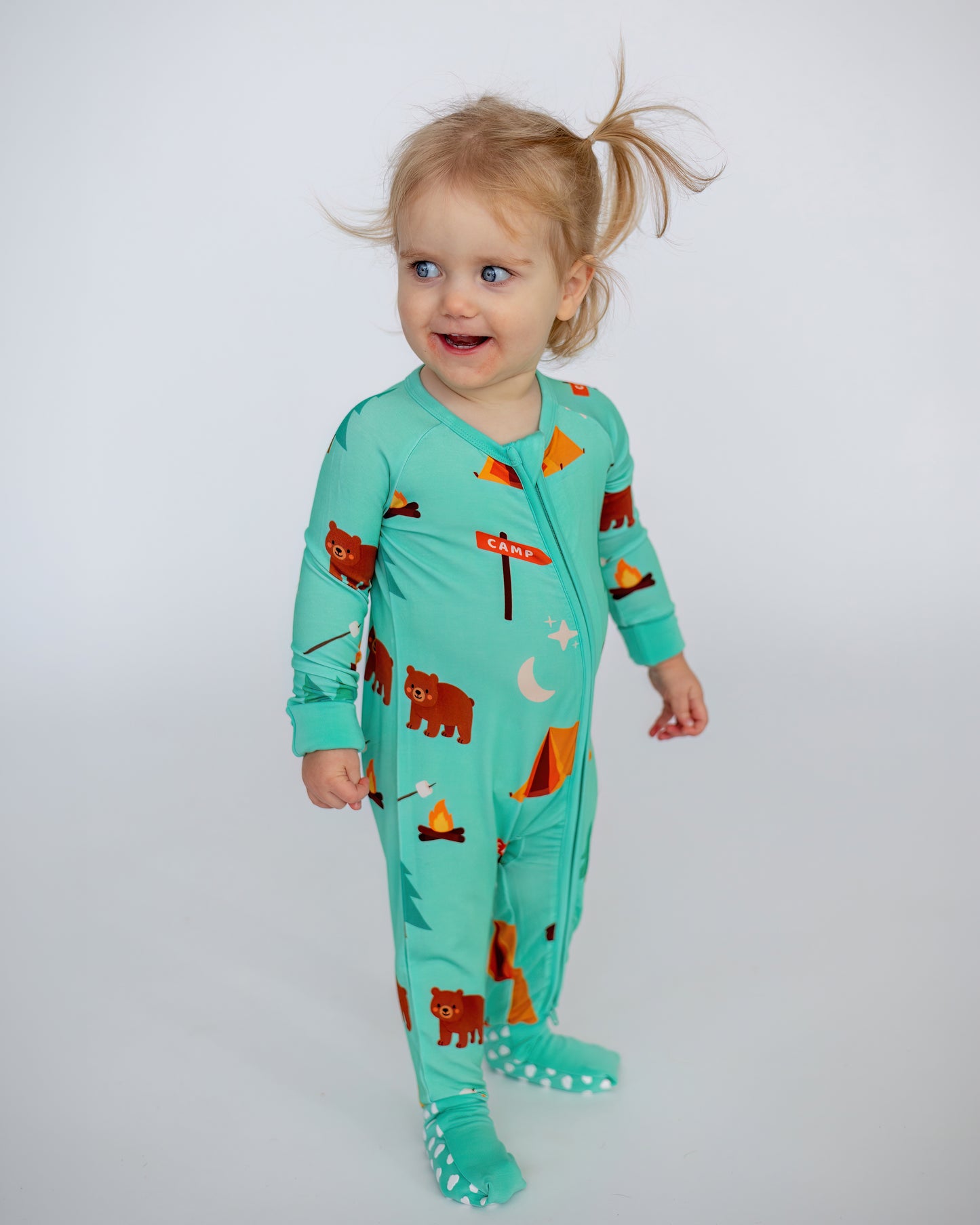 Toddler's aqua camping onesie with bear and tent prints, made from soft, breathable fabric.