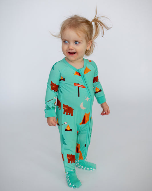 Toddler's aqua camping onesie with bear and tent prints, made from soft, breathable fabric.