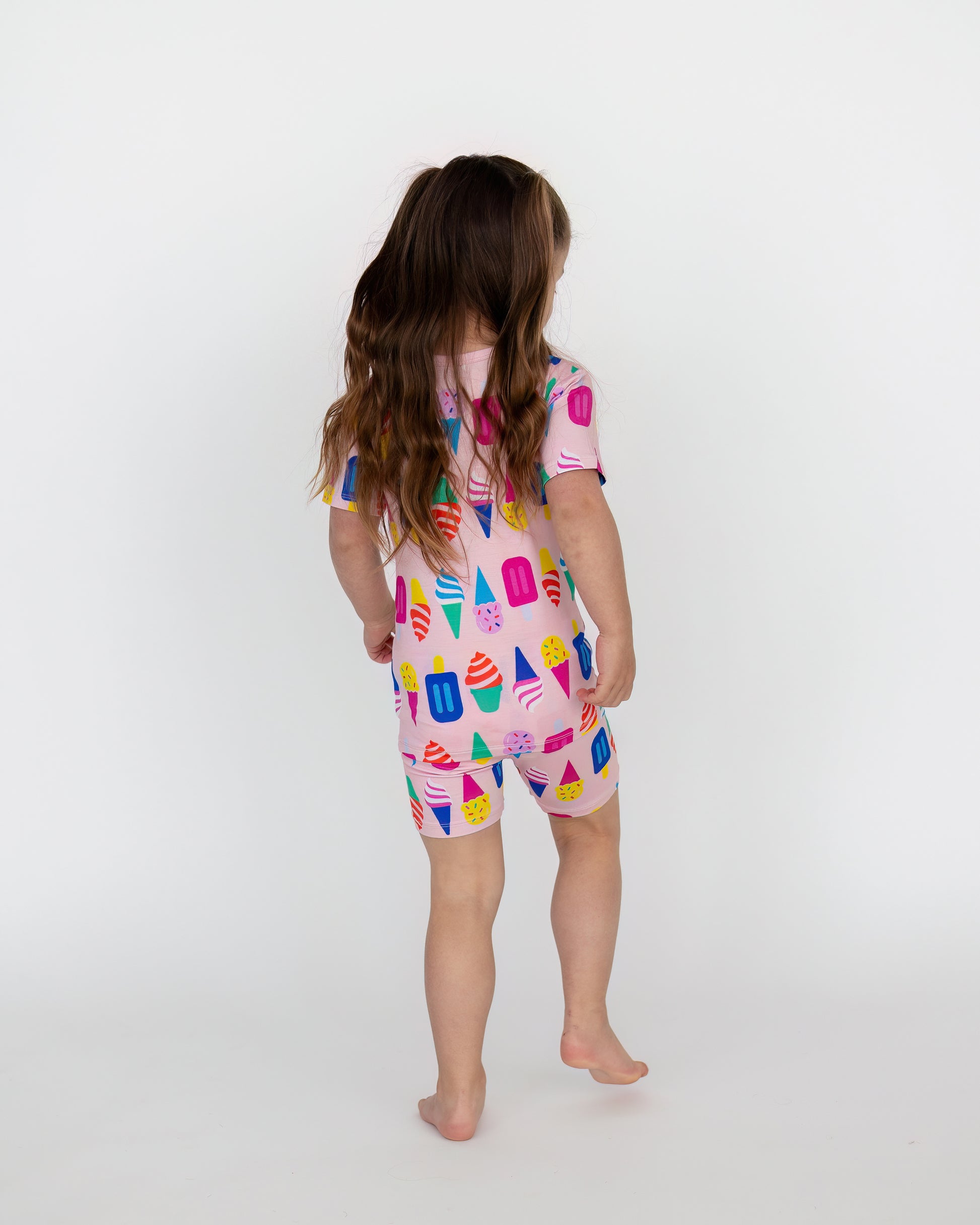Child's colorful ice cream print romper in pink, ideal for summer fun, made from soft, breathable fabric.