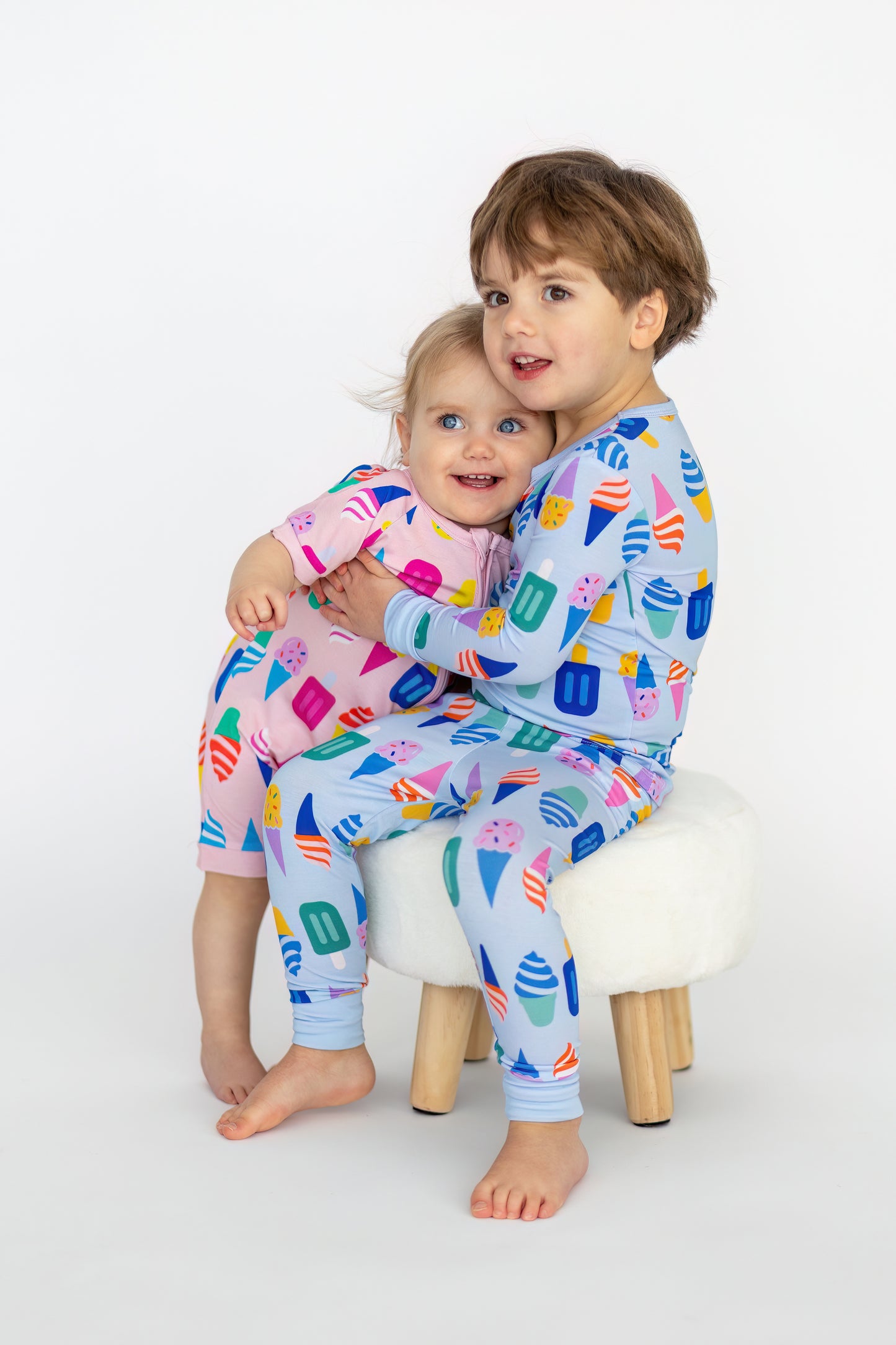 Colorful kids' pajamas set featuring ice cream patterns in pink and blue, made from soft, breathable fabric.