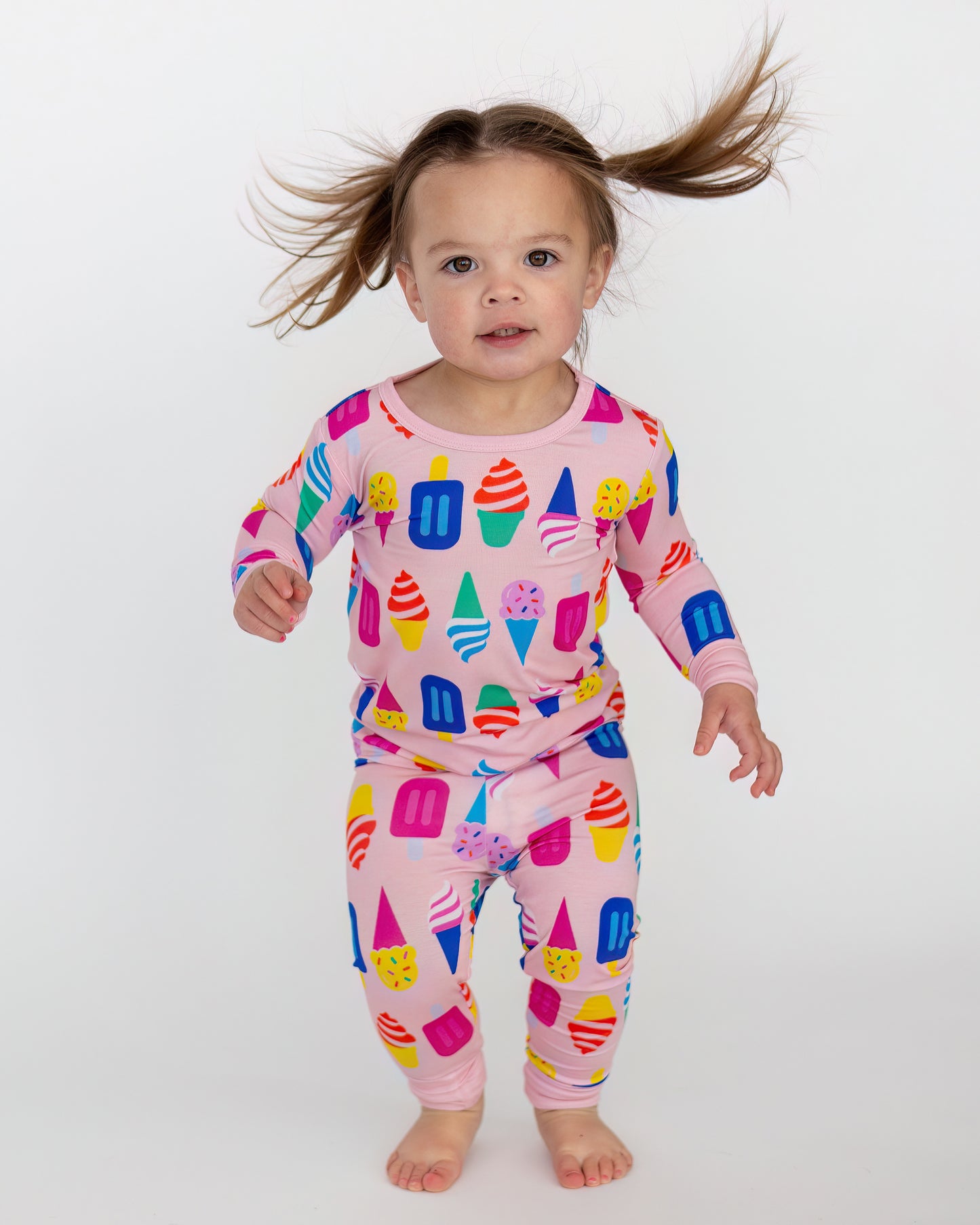 Colorful kids' pajamas set featuring ice cream and popsicle prints, soft pink fabric, full sleeves.