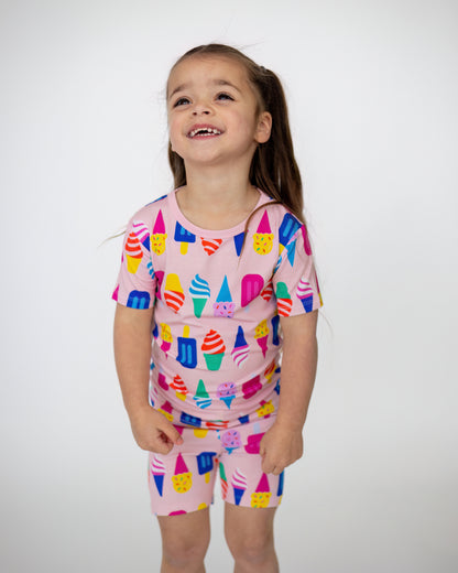 Kids' pink ice cream print pajamas, 100% cotton, featuring short sleeves and shorts for comfort.