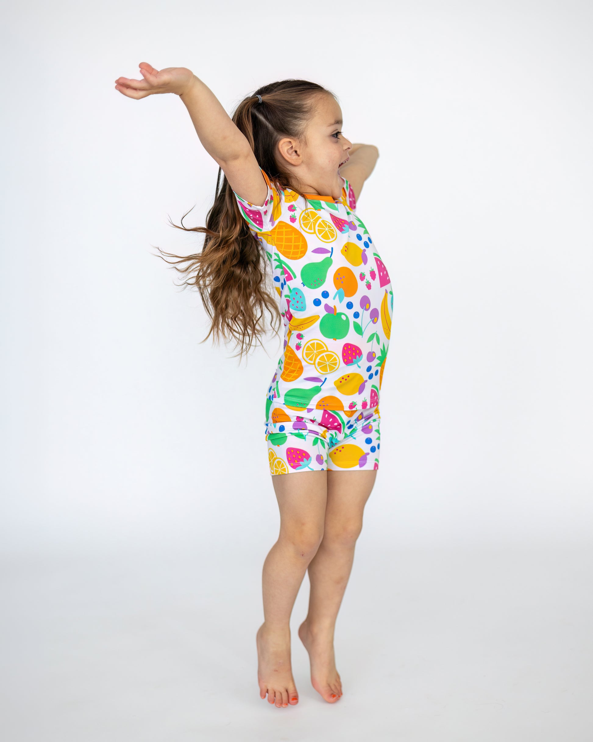Colorful kids' swimsuit featuring fruit patterns, made from soft, durable material, perfect for summer fun.