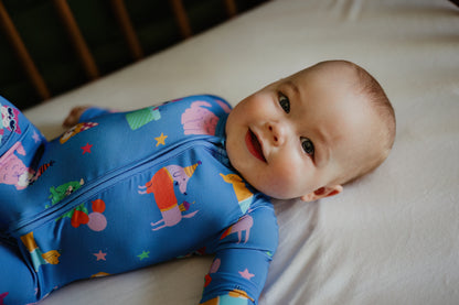 Adorable baby in a colorful blue onesie with fun animal prints, perfect for comfort and play.