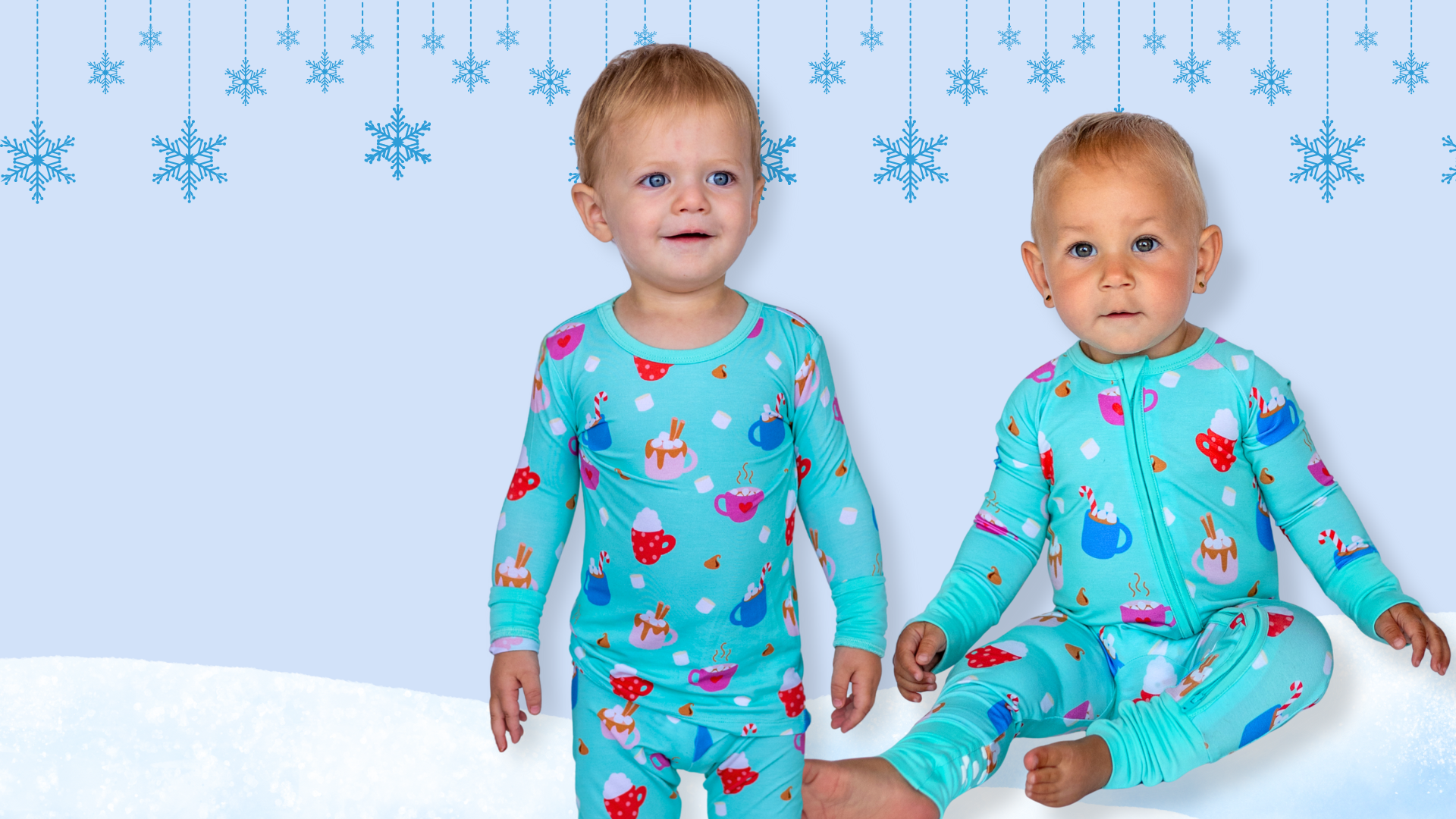 Two children wearing colorful pajamas against a blue snowy background